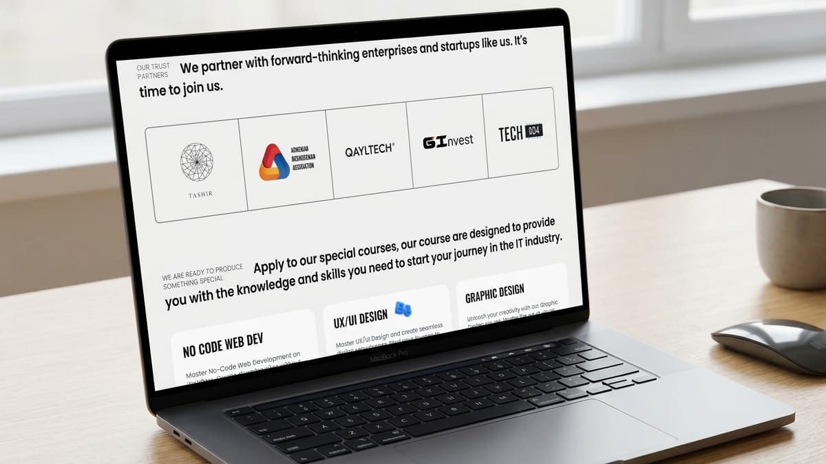 Laptop screen displaying a partners logo grid (including Tashir, QaylTech, and GInvest) and a promotional banner for courses like No Code Web Dev and UX/UI Design.